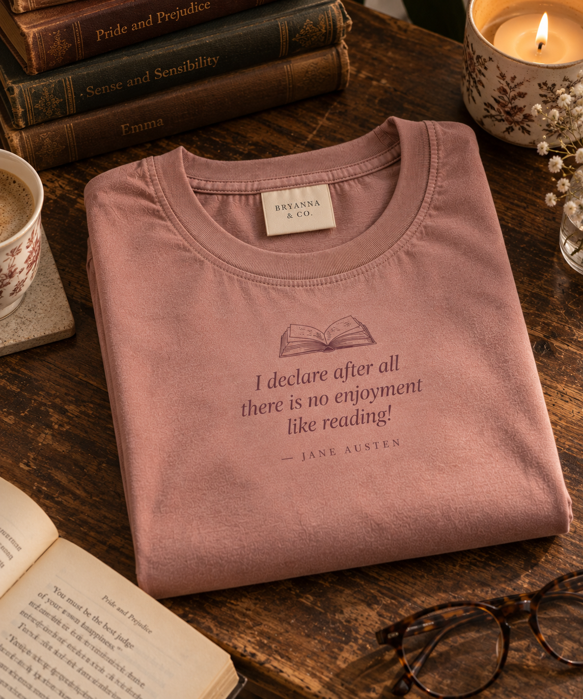 Antique Rose relaxed-fit tee printed with “I declare after all there is no enjoyment like reading!” in mauve serif type, folded on a linen backdrop